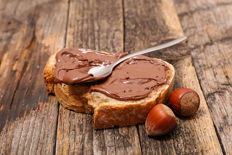 A slice of bread topped with Nutella spread