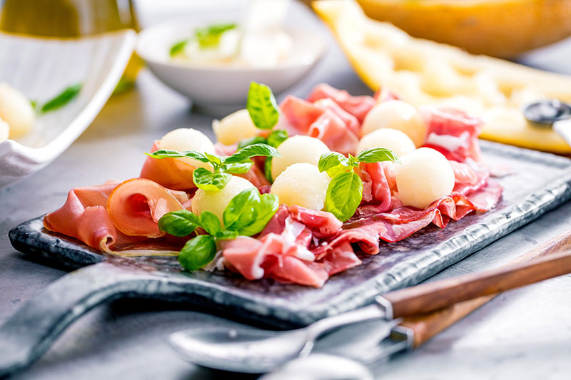 Italian dry cured ham served with melon balls