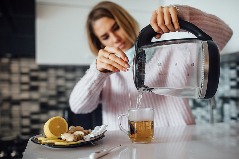 Preparing a cup of hot ginger tea