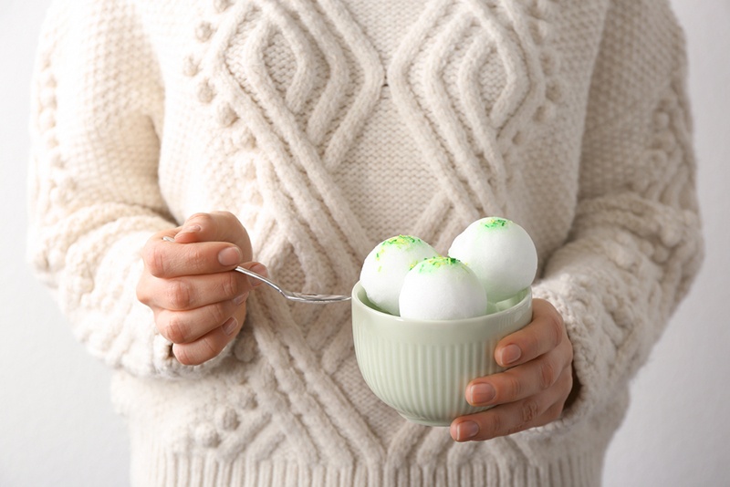 Woman eating snow ice cream from a bowl