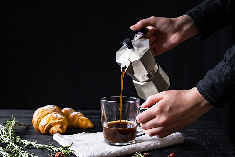 Pouring coffee from an Italian coffee pot