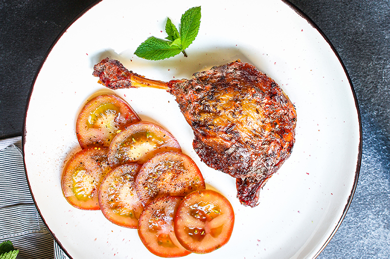 Confit de canard served with tomatoes