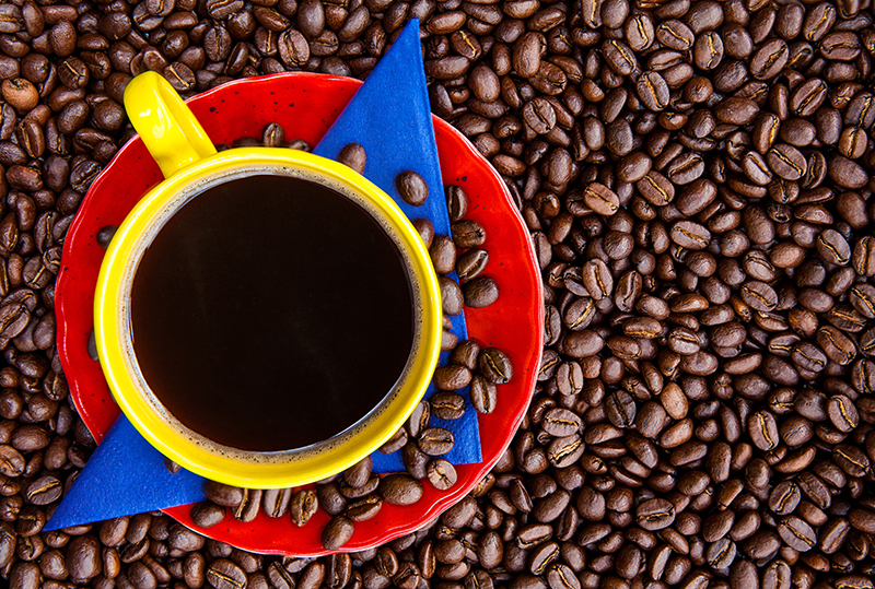 Cup of Colombian coffee and the colors of the Colombian flag