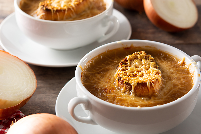 Tasty French onion soup served in a cup